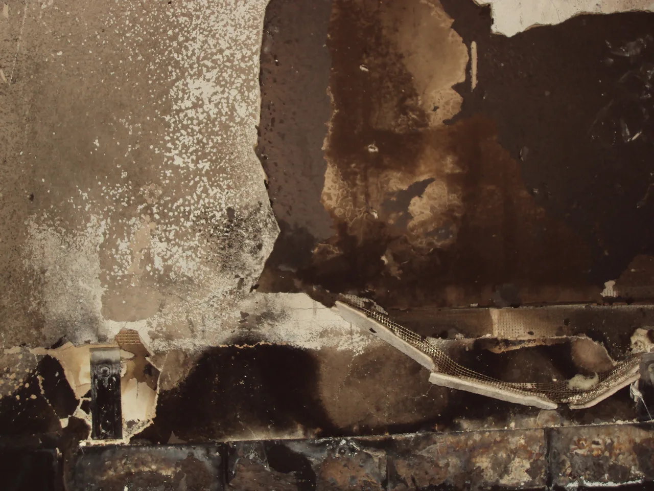 Fire-damaged wall with visible surface damage